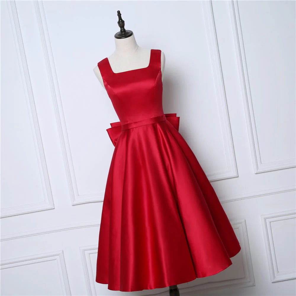 Vestidos de fiesta sexys con tirantes y espalda abierta de satén con lazo y largo hasta la rodilla 