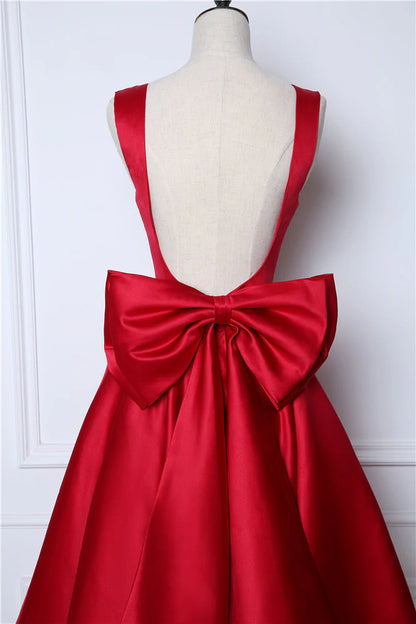Vestidos de fiesta sexys con tirantes y espalda abierta de satén con lazo y largo hasta la rodilla 