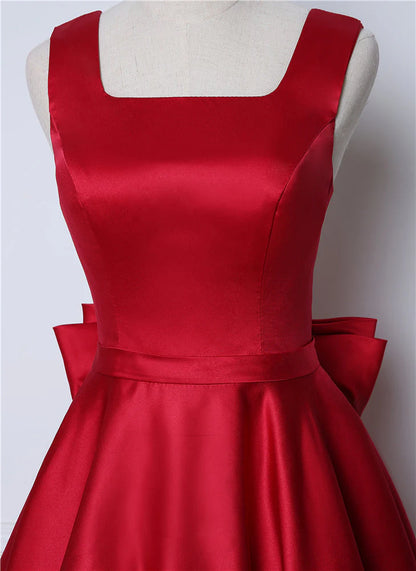 Vestidos de fiesta sexys con tirantes y espalda abierta de satén con lazo y largo hasta la rodilla 