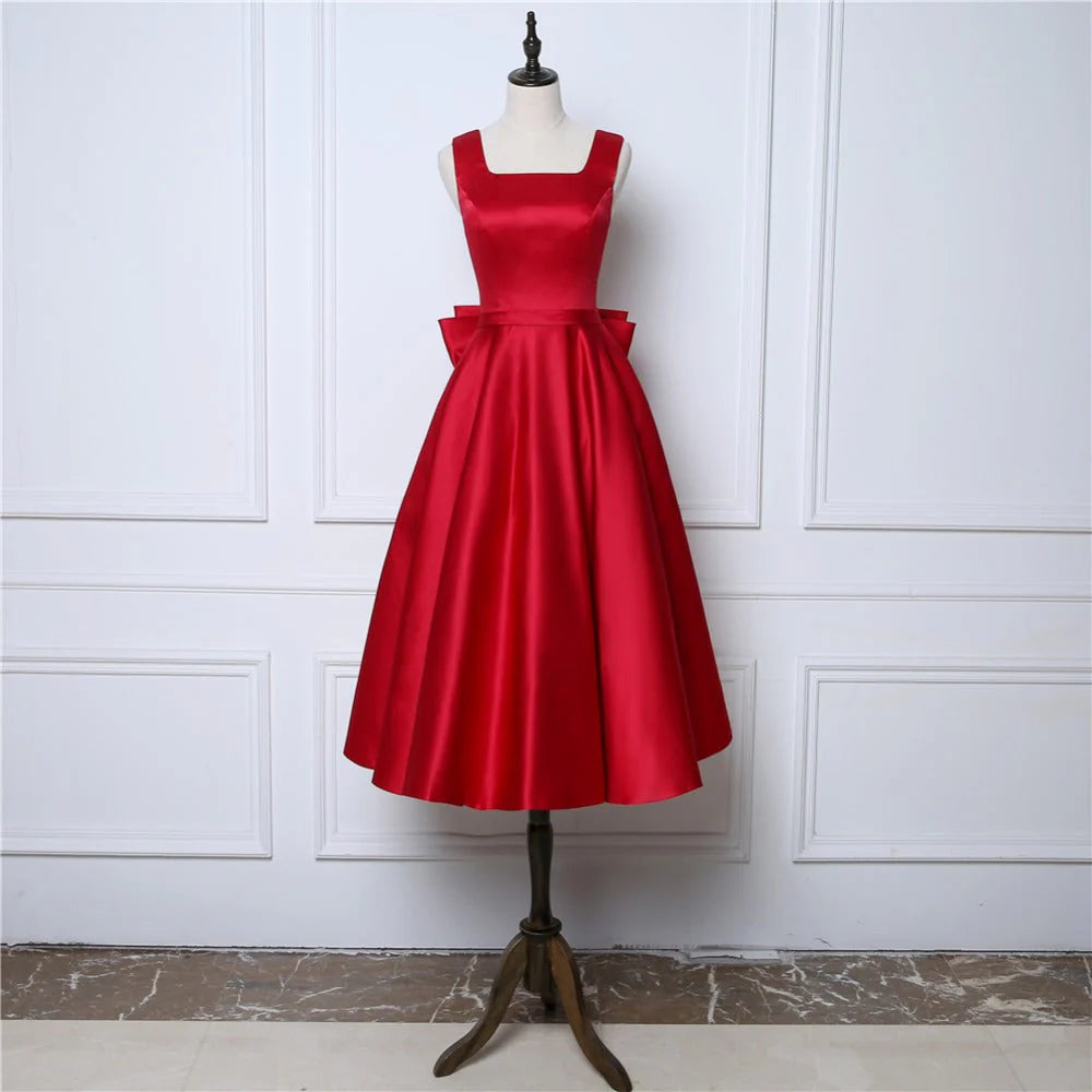 Vestidos de fiesta sexys con tirantes y espalda abierta de satén con lazo y largo hasta la rodilla 