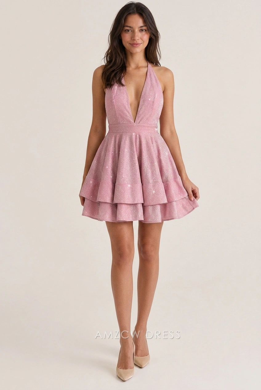 Model wearing a sparkling pink A-line halter V-neck tiered short homecoming dress with open back.
