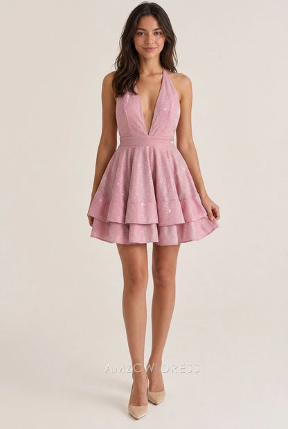 Model wearing a sparkling pink A-line halter V-neck tiered short homecoming dress with open back.
