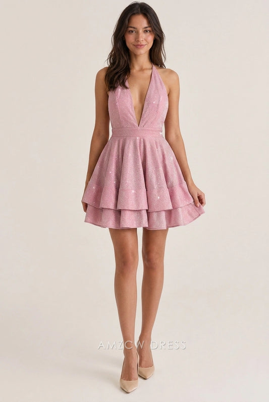 Model wearing a sparkling pink A-line halter V-neck tiered short homecoming dress with open back.