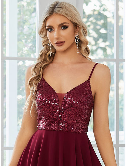 Model posing in the sleeveless A-line homecoming dress.