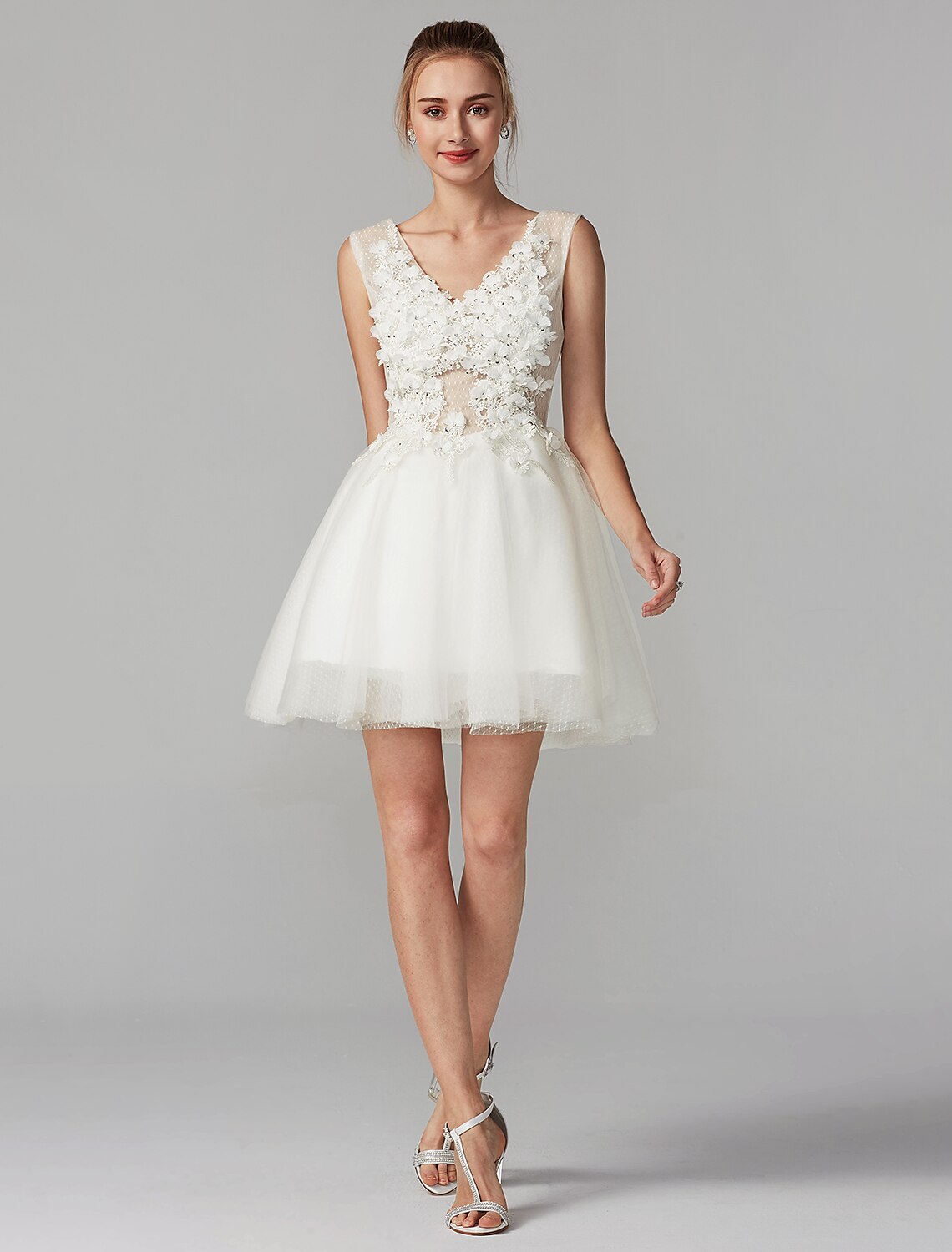 Detail of V-neckline and sleeveless design.