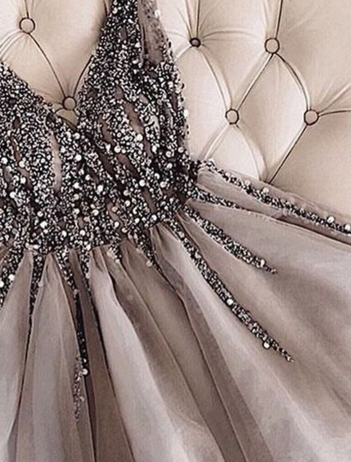 Side profile of a sleeveless V-neck mini dress with sparkle.
