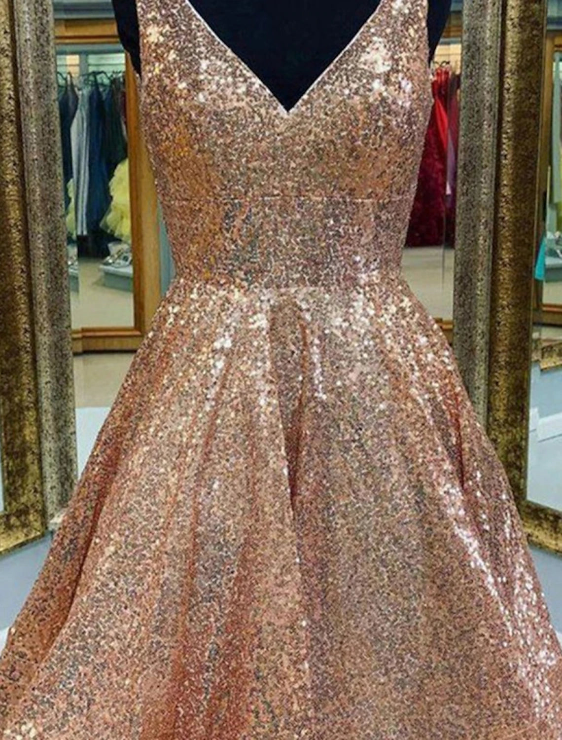 Sparkling pink A-line dress with sequin details, tea-length cut.