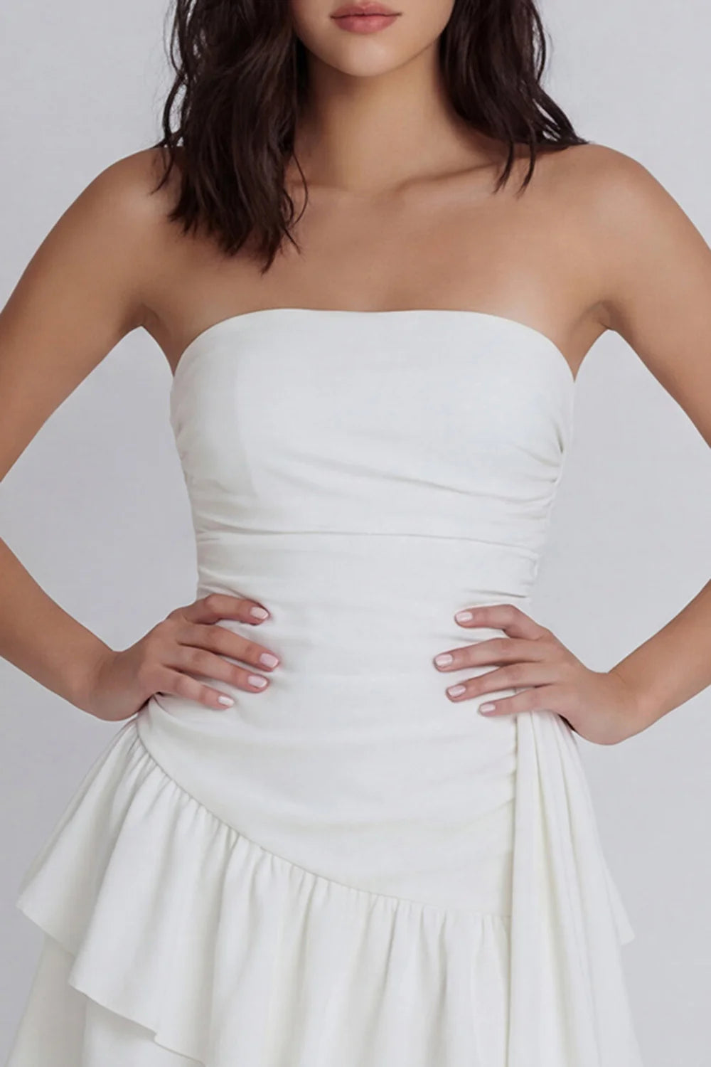 Strapless White Homecoming Dress with Ruched Bodice, Asymmetrical Tiered Ruffle Skirt and Draped Sash Detail