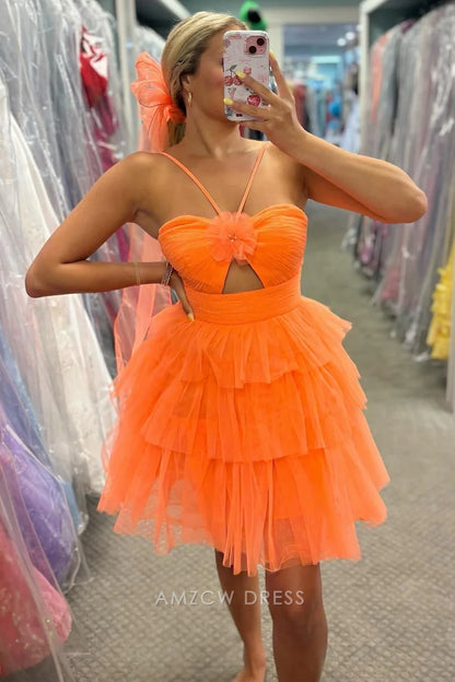 Close-up of the tiered ruffle skirt and sweetheart neckline of the orange homecoming dress.