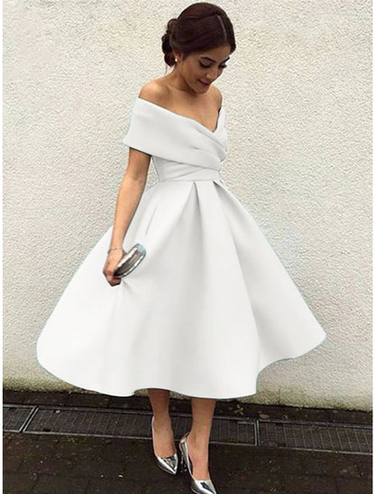 Woman twirling in a 1950s A-line tea length cocktail dress, showcasing the flow of the skirt.