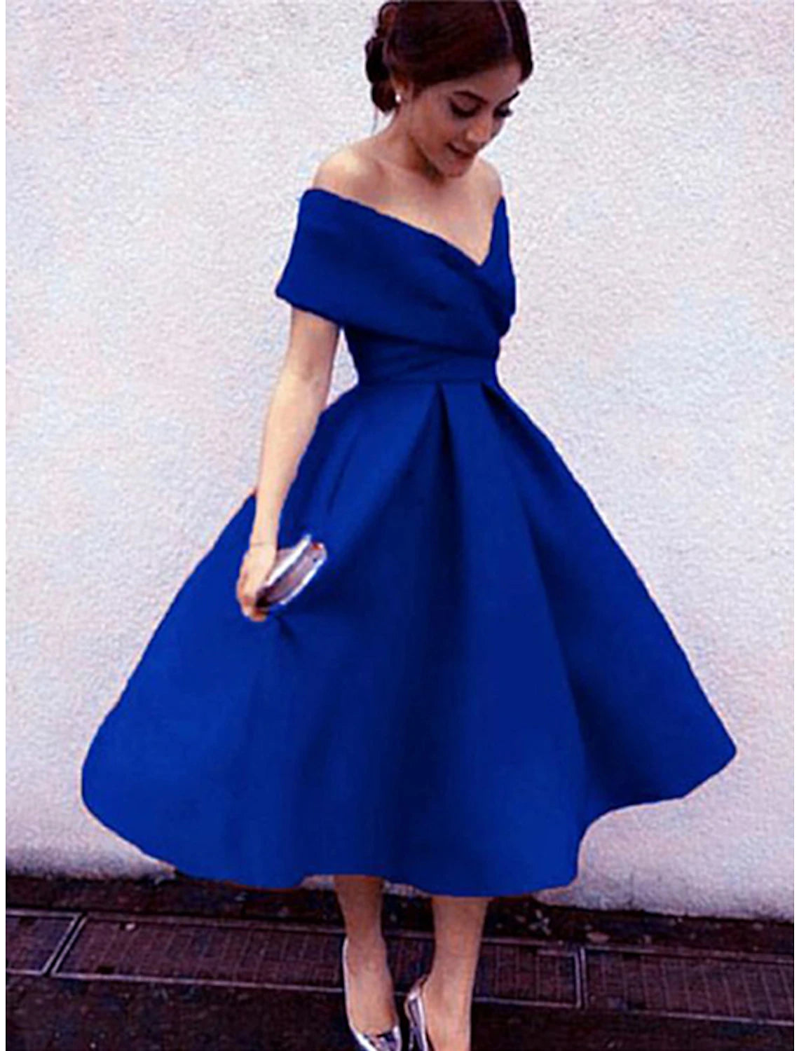 Detailed view of the pleated skirt and stretch fabric of the 1950s A-line cocktail dress.