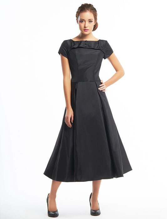Vintage A-line tea length homecoming dress with short sleeves and boat neck.