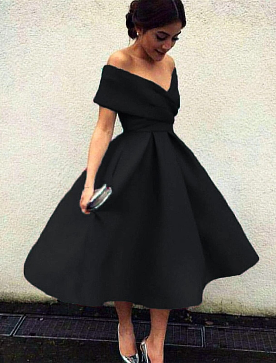 Close-up of the pleated skirt and stretch fabric of the A-line tea length dress.