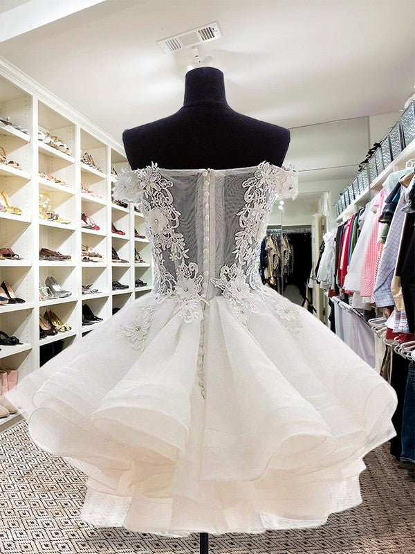 Back view of a white organza off-the-shoulder short ball gown with intricate applique.