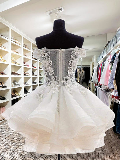 Back view of a white organza off-the-shoulder short ball gown with intricate applique.