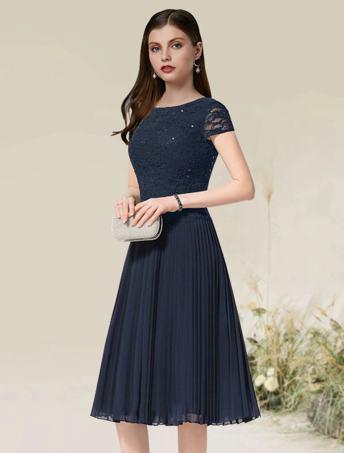 Side view of a tea-length A-line dress with delicate pleats.
