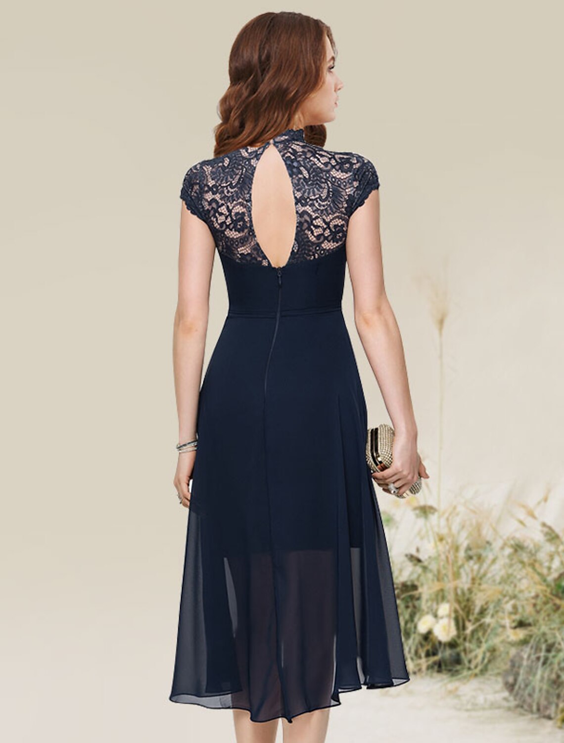 Back view of an A-line asymmetrical chiffon homecoming dress with lace inserts.