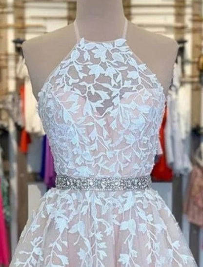 Close-up of the intricate floral appliques on the bodice of a halter neck dress.