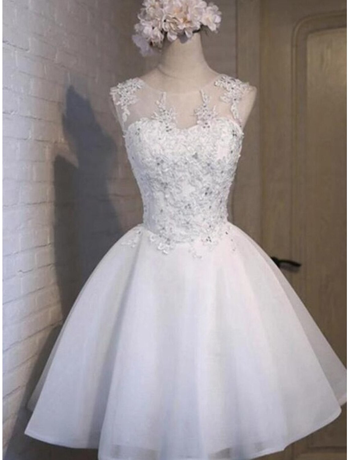 A-line floral tulle homecoming dress with appliques and a jewel neck.