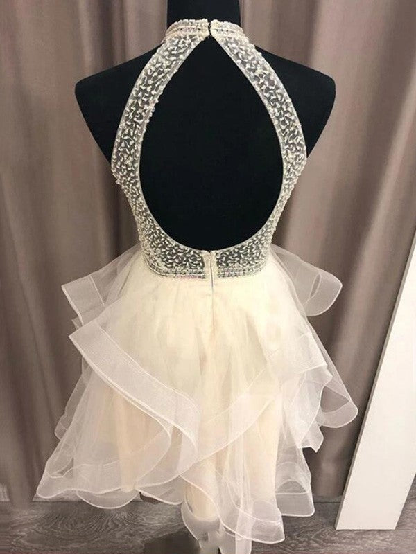 Side view of an A-Line organza mini dress, showcasing the beaded halter and flowing skirt.