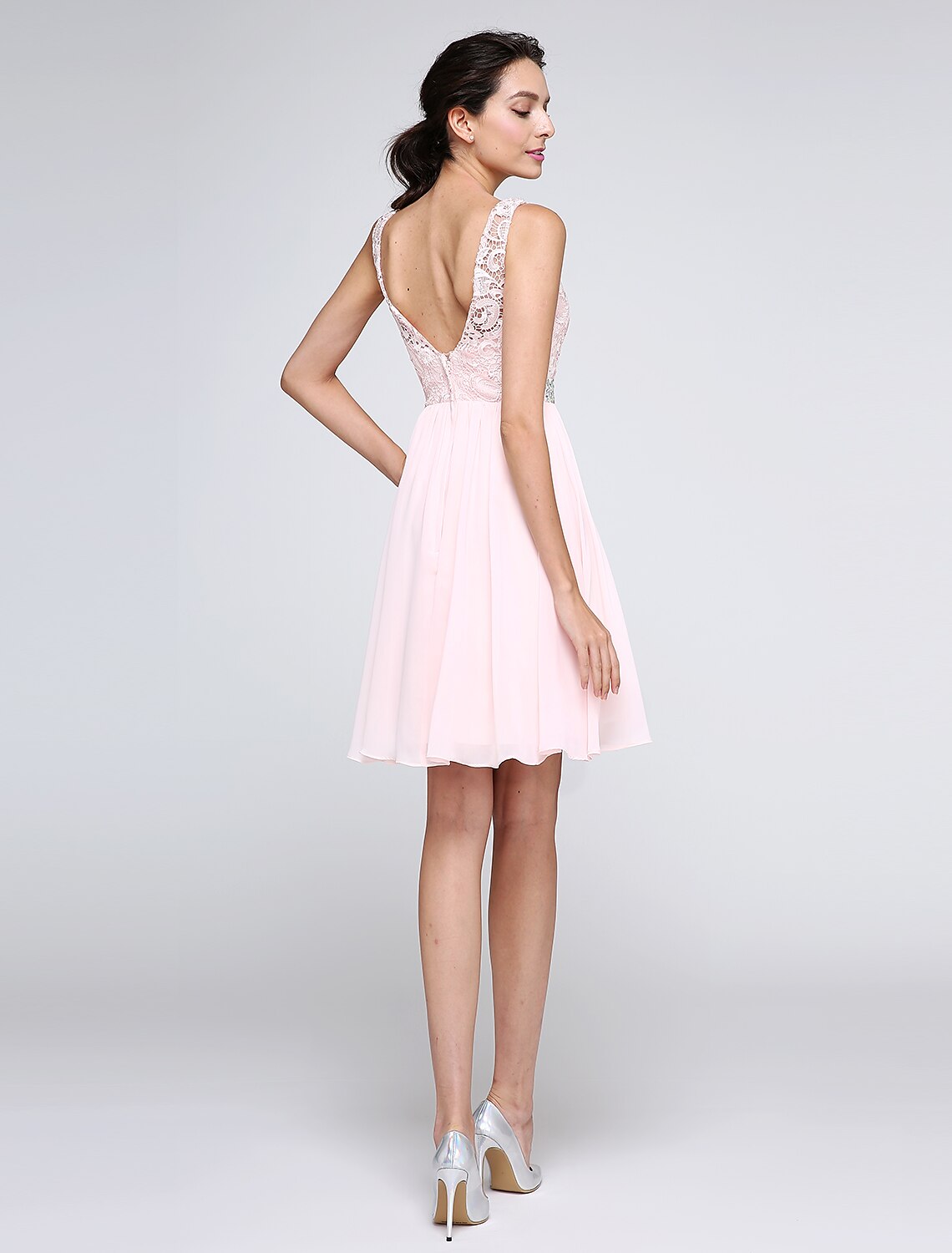 Back view of A-Line dress showing V-back and crystal embellishments.