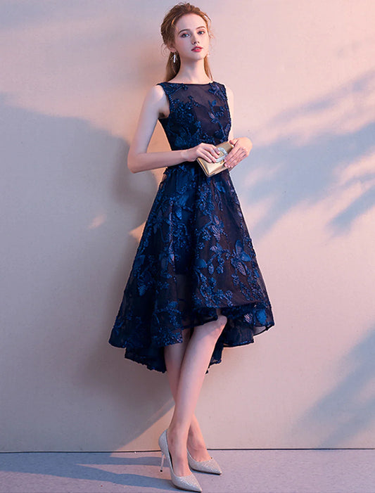 Woman wearing an A-line asymmetrical tulle cocktail dress with a jewel neck.