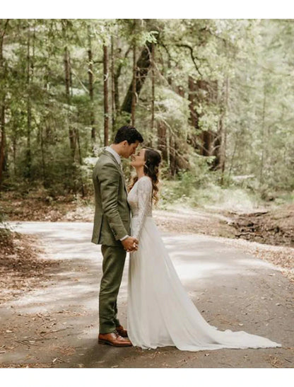 Model wearing a Boho A-Line lace wedding dress with long sleeves and open back.
