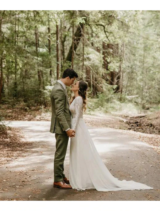 Model wearing a Boho A-Line lace wedding dress with long sleeves and open back.