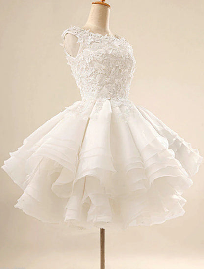 Model in a white floral ball gown cocktail dress with jewel neck.