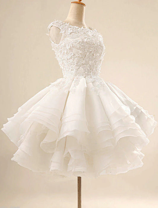Model in a white floral ball gown cocktail dress with jewel neck.
