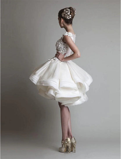 Back view of a white short ball gown featuring delicate floral appliques.