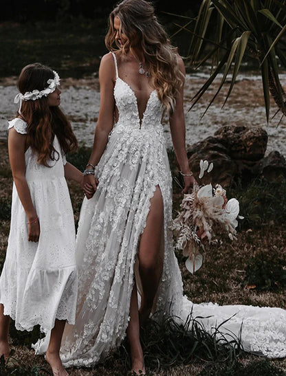 Back view of boho wedding gown showing court train and spaghetti straps.