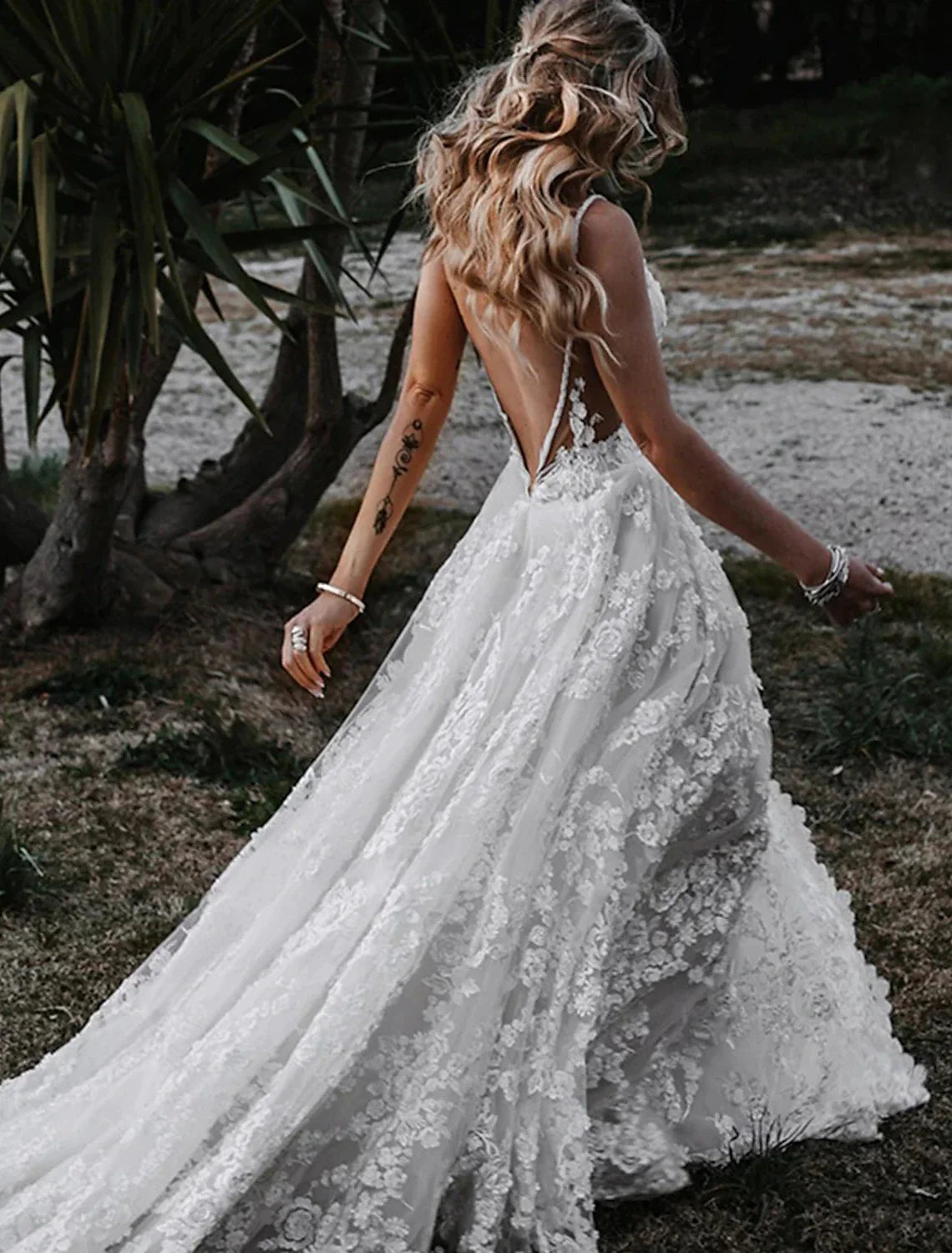 Elegant boho wedding dress with sweetheart neckline and court train detail.