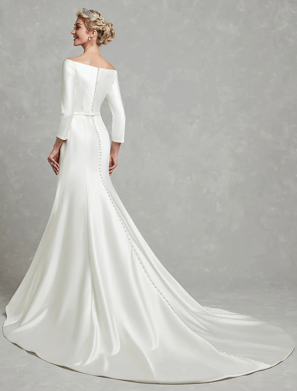 Side profile of an elegant off-shoulder wedding dress.