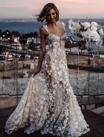 Back view of a bride in a mermaid trumpet wedding dress, showcasing the court train and lace details.