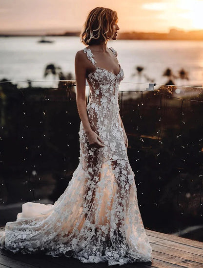 Side view of a bride in an elegant lace mermaid wedding gown with a sweetheart neckline.