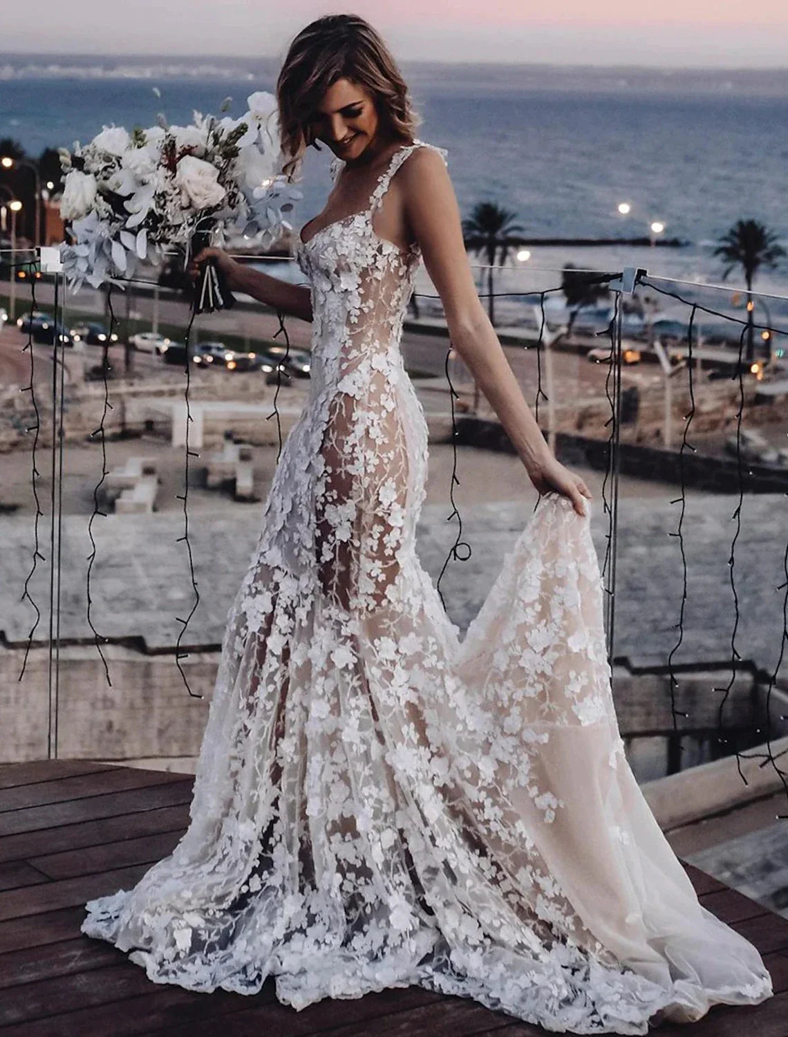 Close-up of the lace appliques and sweetheart neckline on a bridal gown.