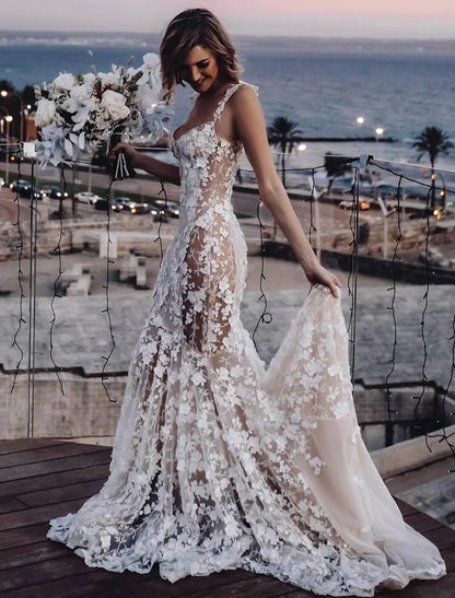 Close-up of the lace appliques and sweetheart neckline on a bridal gown.