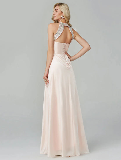 Side profile of the model in the flowing black A-line evening dress.