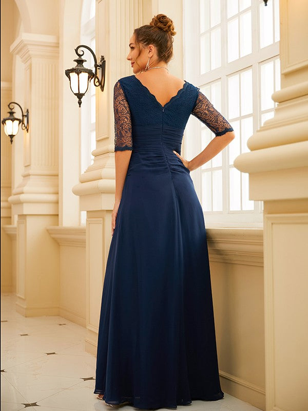 Front view of a woman wearing a light blue V-neck chiffon gown.