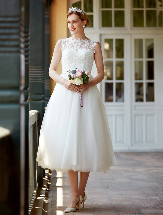 Model wearing an elegant A-Line illusion neck lace tea length white bridal gown.