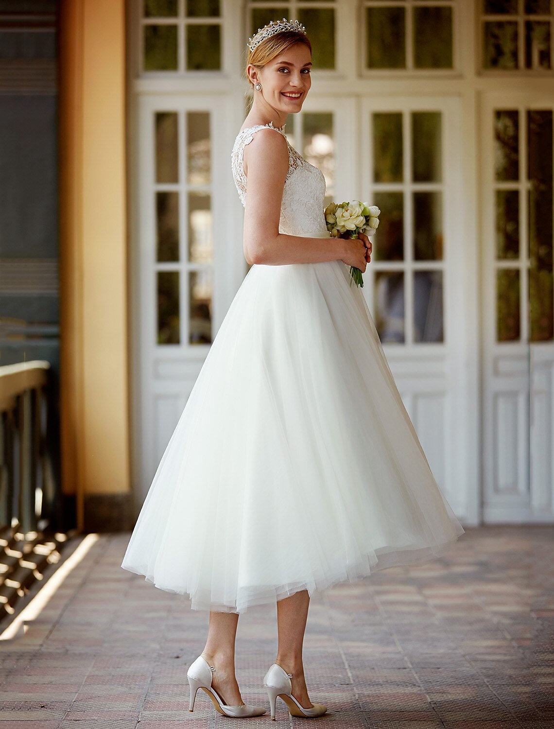 Back view of the A-Line white bridal gown showing sashes and buttons.