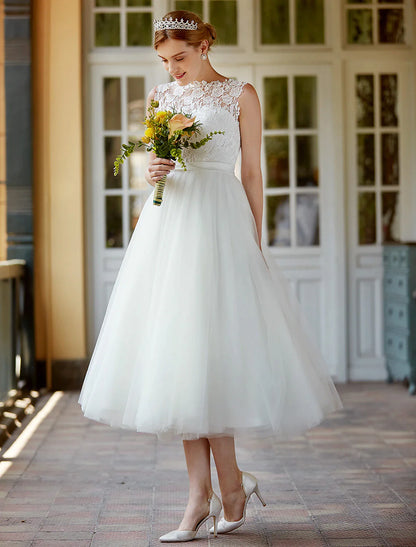 Close-up of the illusion neckline and lace details on the white bridal gown.