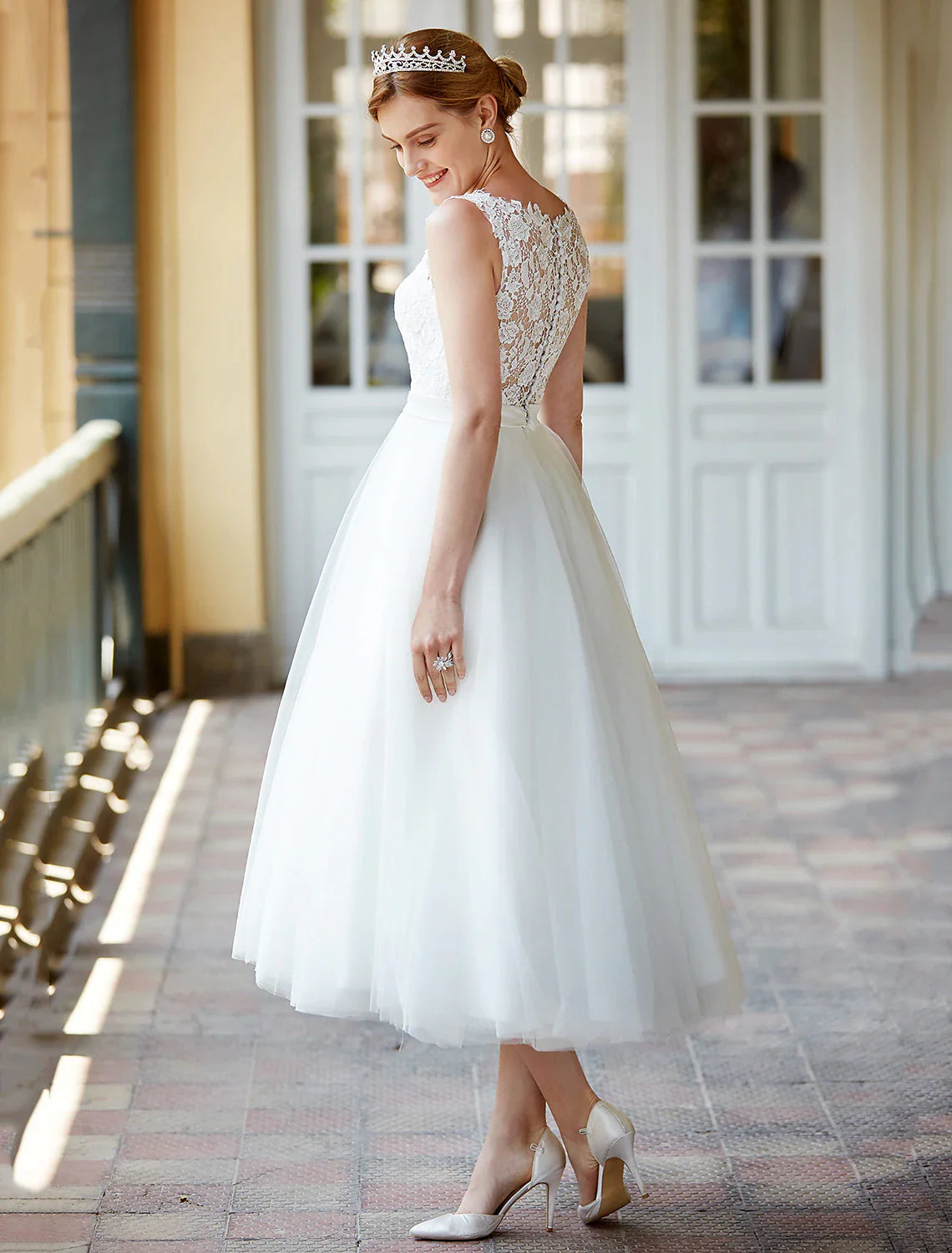 Detailed view of the lace pattern and fabric of the white bridal gown.
