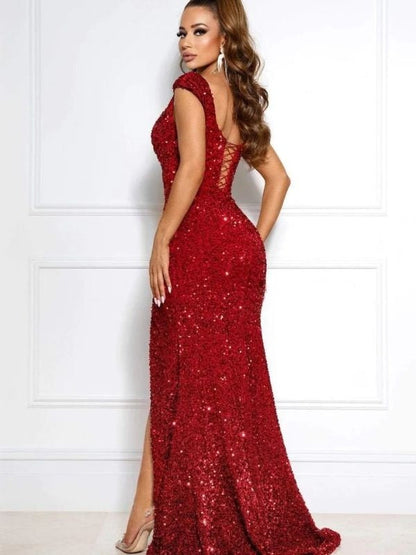 Side view of a model in a black A-line one-shoulder ruched long sleeve dress.