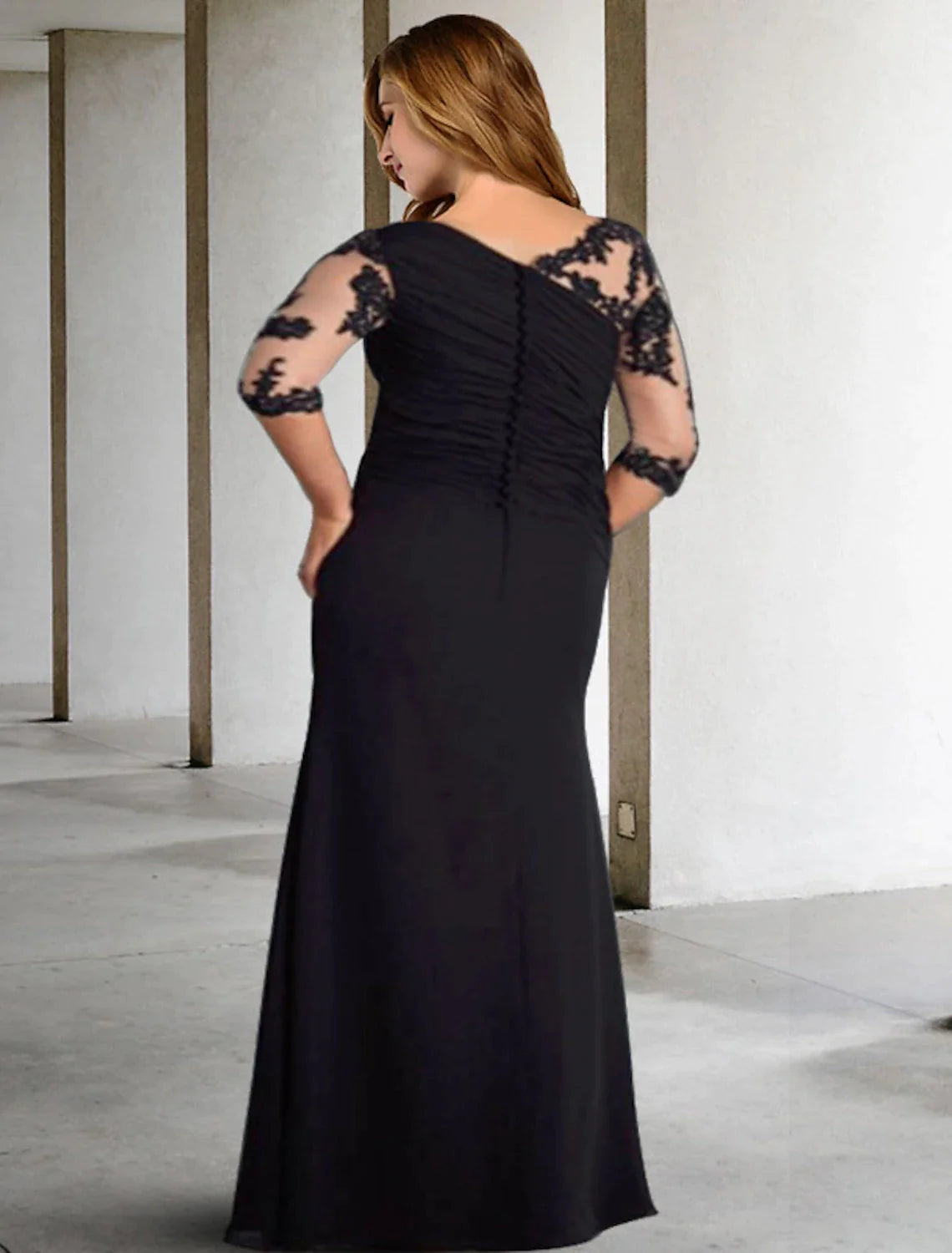 Formal floor-length plus size wedding guest dress featuring pleats, ruching, and appliques.