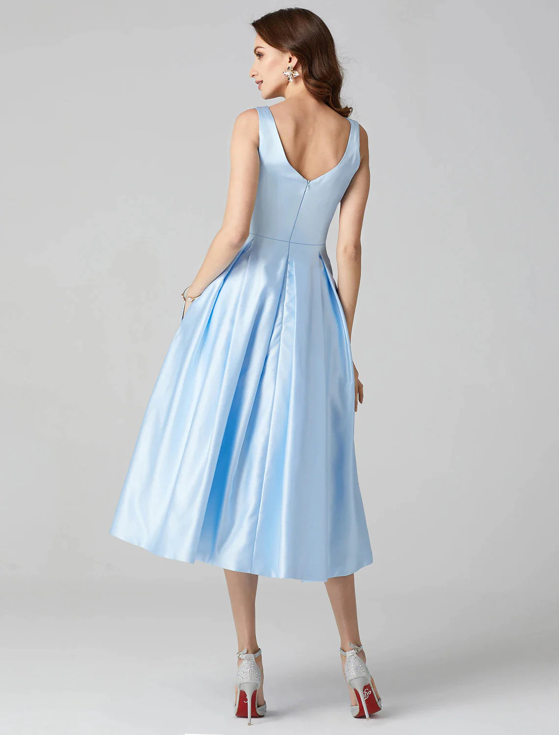Sleeveless formal party dress in A-Line silhouette with pleats and pockets.