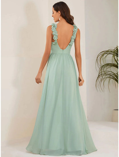 Full view of a woman posing in a sleeveless A-line chiffon formal gown.