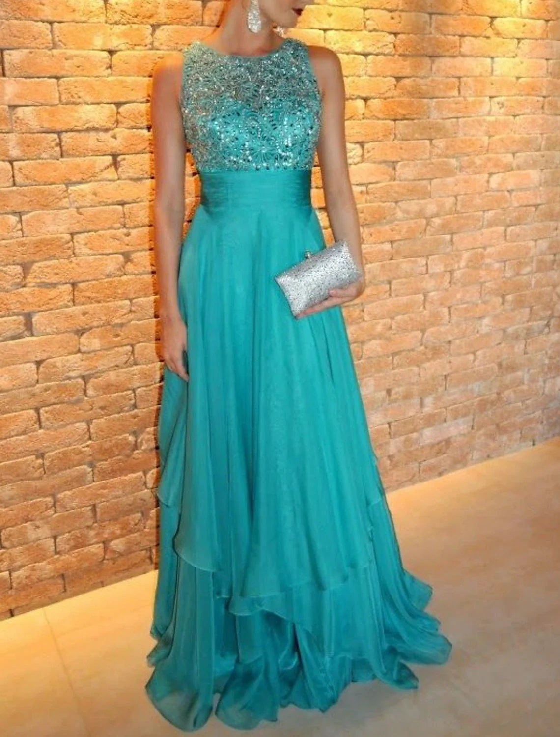 Sleeveless A-line prom dress featuring a flowing tiered chiffon skirt.