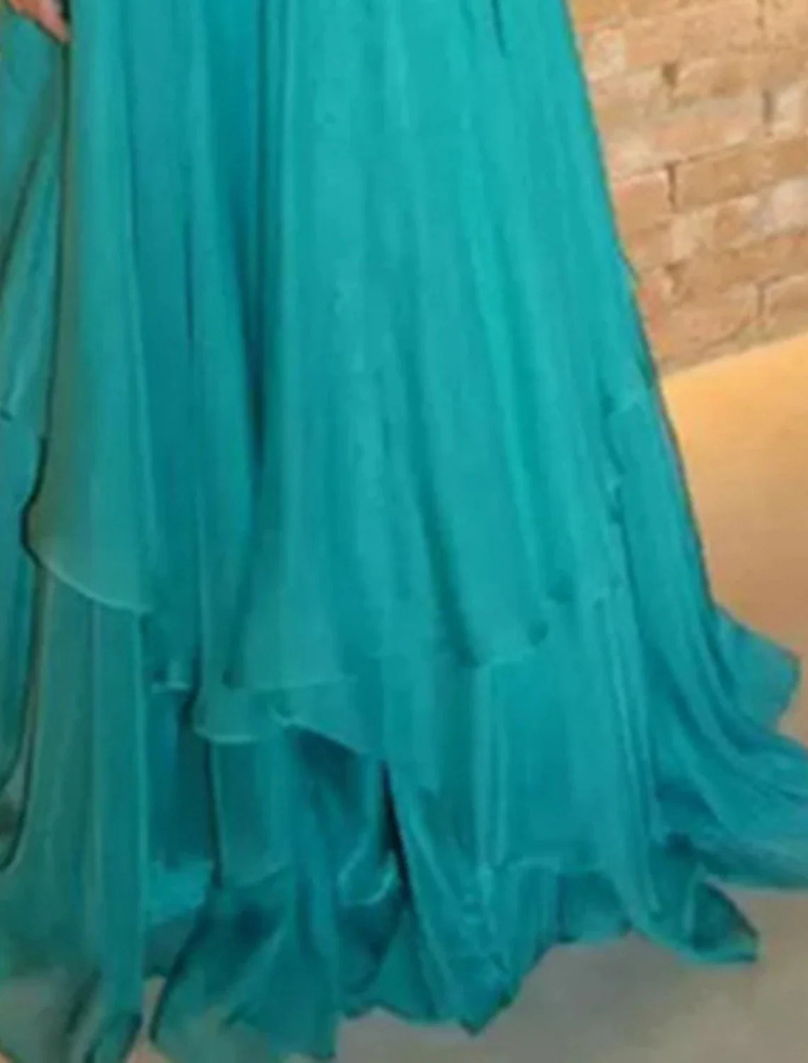 Close-up of the jewel neck and rhinestone embellishments on the A-line gown.